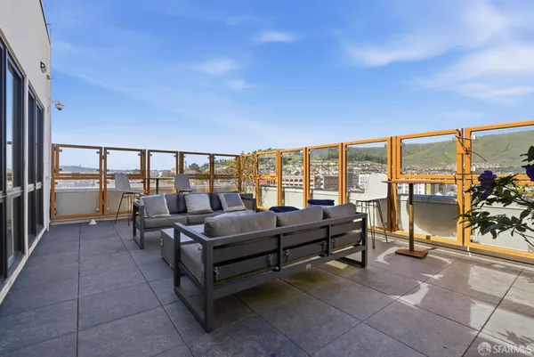 a living room with furniture and a floor to ceiling window