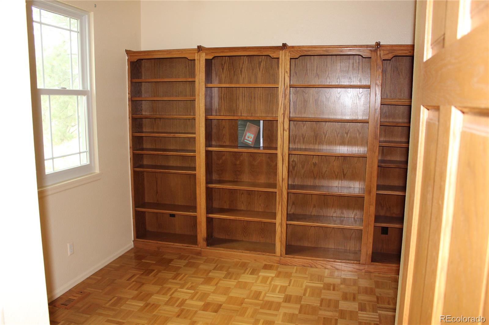 37622 Sable Ridge Road Elizabeth, CO 80107 - Photo 20 of 32 a room with closet and wooden floor