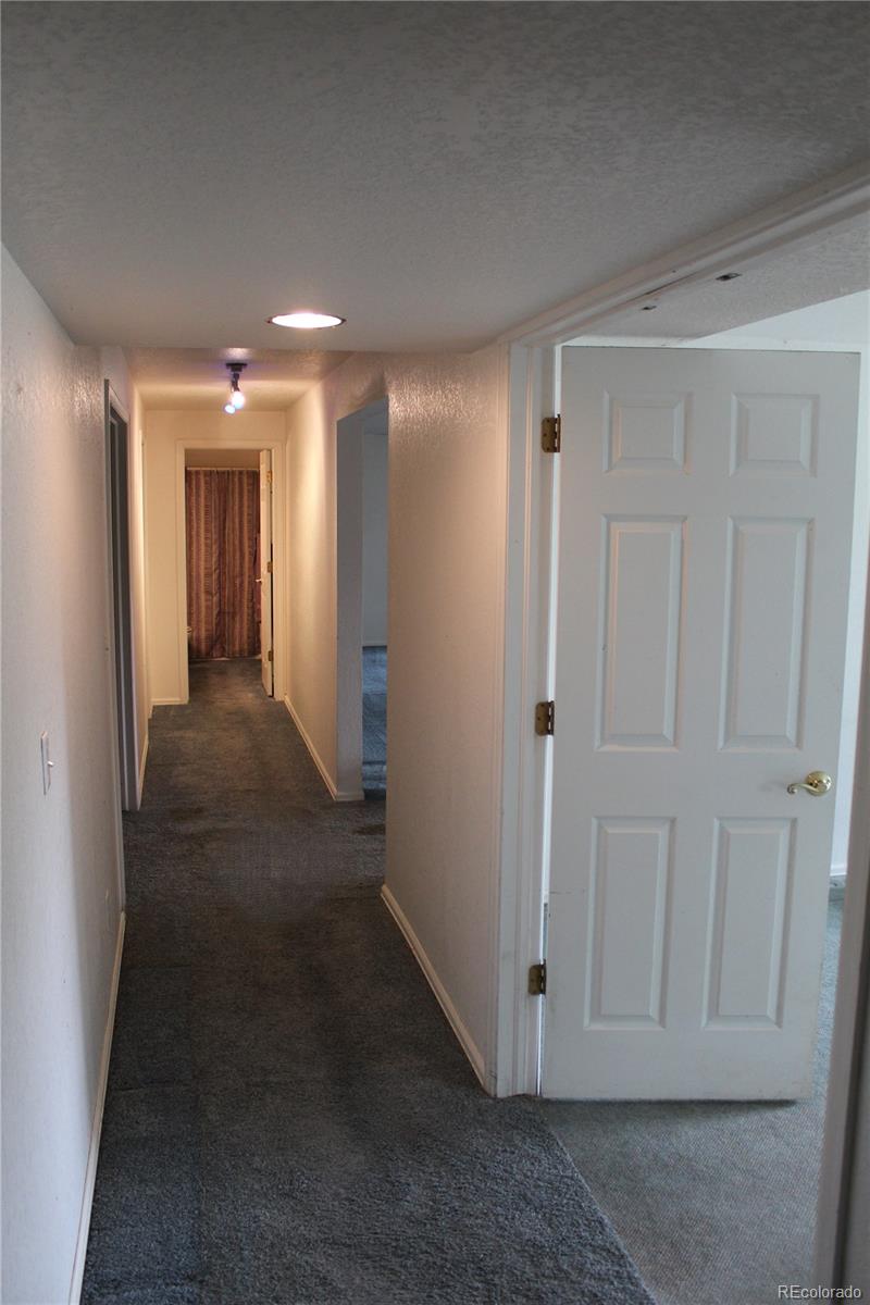 37622 Sable Ridge Road Elizabeth, CO 80107 - Photo 21 of 32 a view of a hallway with wooden floor and closet area