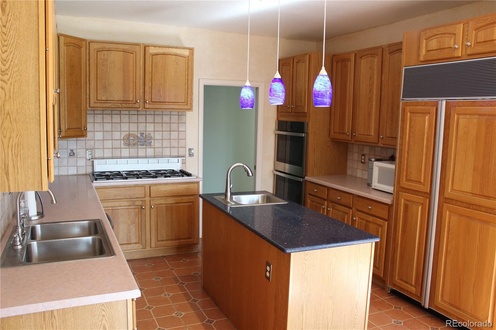 37622 Sable Ridge Road Elizabeth, CO 80107 - Photo 4 of 32 a kitchen that has a sink cabinets counter space and appliances