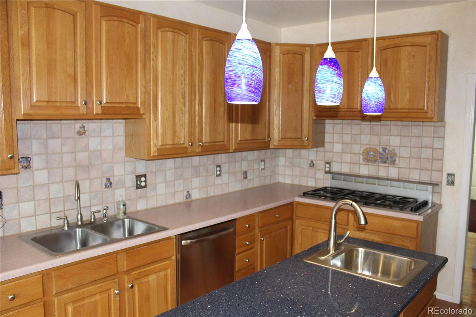 37622 Sable Ridge Road Elizabeth, CO 80107 - Photo 5 of 32 a kitchen with stainless steel appliances granite countertop a sink a stove and a wooden cabinets