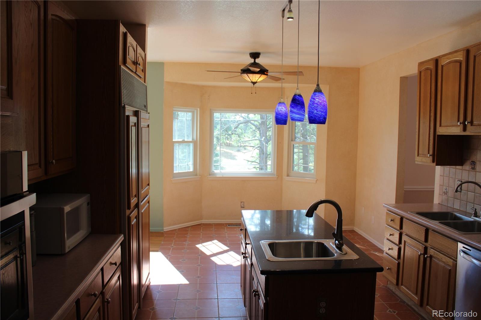 37622 Sable Ridge Road Elizabeth, CO 80107 - Photo 6 of 32 a kitchen with a sink appliances and cabinets