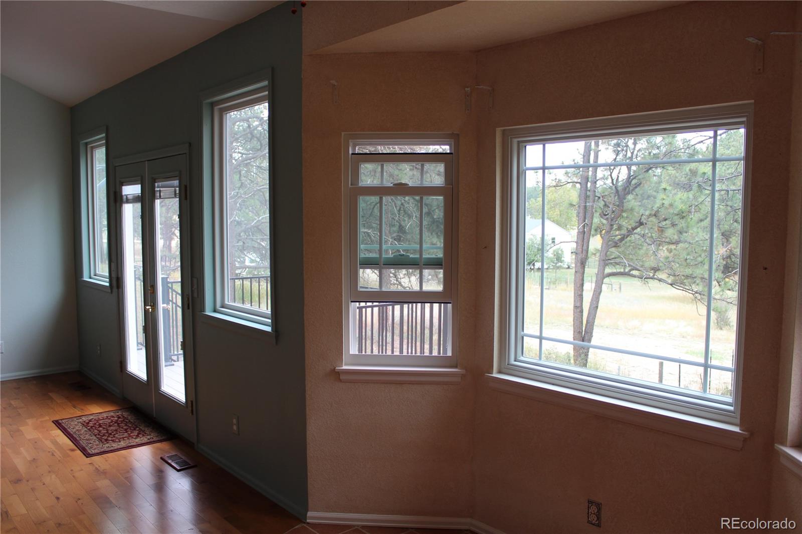 37622 Sable Ridge Road Elizabeth, CO 80107 - Photo 10 of 32 a view of an empty room with wooden floor and a window