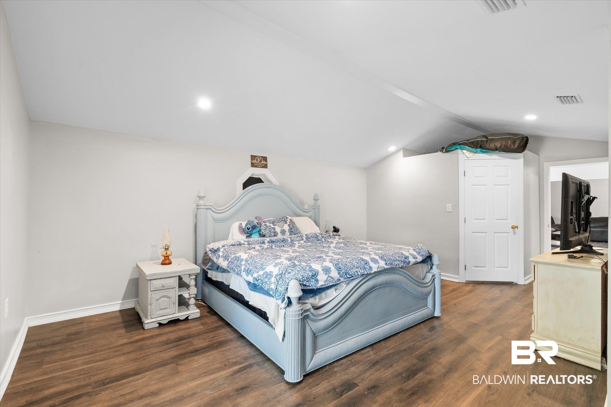 529 Cleveland Road Saraland, AL 36571 - Photo 12 of 31 Bedroom with baseboards, vaulted ceiling, recessed lighting, dark wood-type flooring, and visible vents