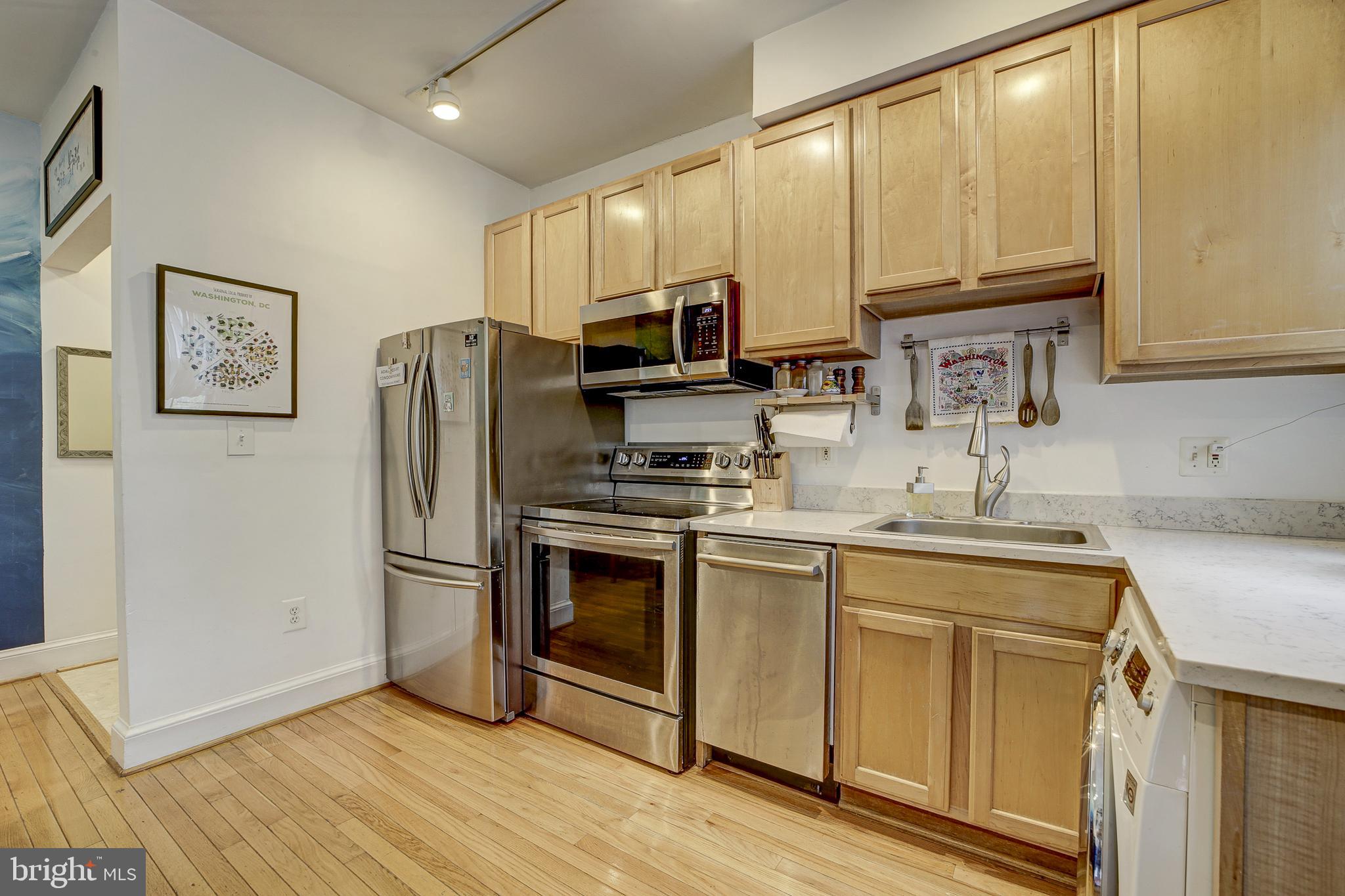 1401 Columbia Road Northwest, Unit 219 Washington, DC 20009 - Photo 11 of 33 a kitchen with stainless steel appliances a refrigerator sink and microwave