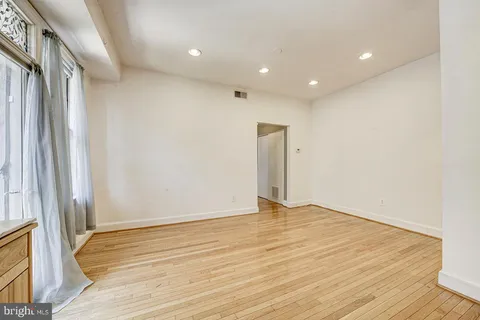 a bathroom with a shower a toilet and a window
