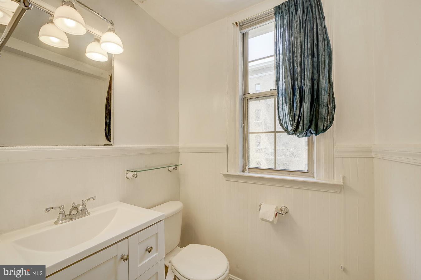 1401 Columbia Road Northwest, Unit 219 Washington, DC 20009 - Photo 16 of 33 a bathroom with a toilet sink and mirror