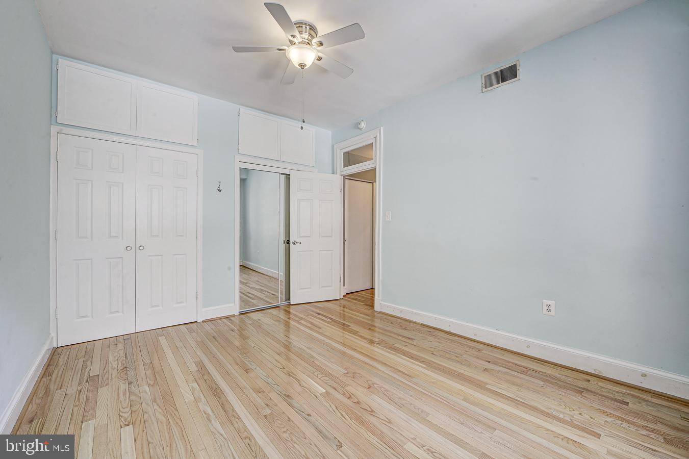 1401 Columbia Road Northwest, Unit 219 Washington, DC 20009 - Photo 19 of 33 a view of empty room with wooden floor and fan