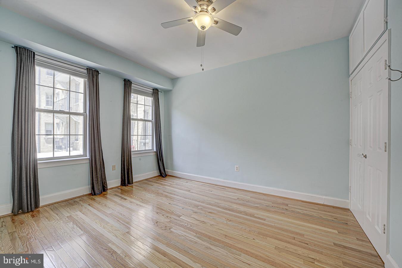 1401 Columbia Road Northwest, Unit 219 Washington, DC 20009 - Photo 20 of 33 a view of an empty room with wooden floor and a window