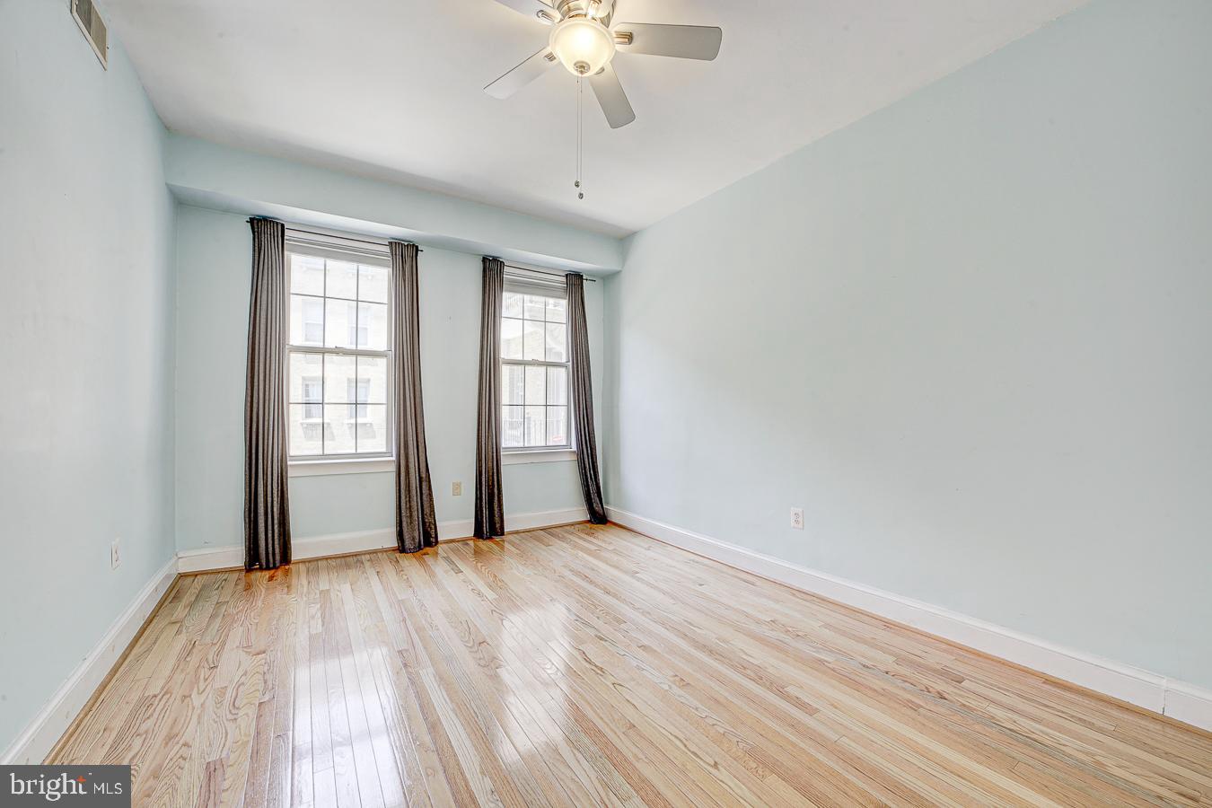 1401 Columbia Road Northwest, Unit 219 Washington, DC 20009 - Photo 21 of 33 wooden floor in an empty room with a window
