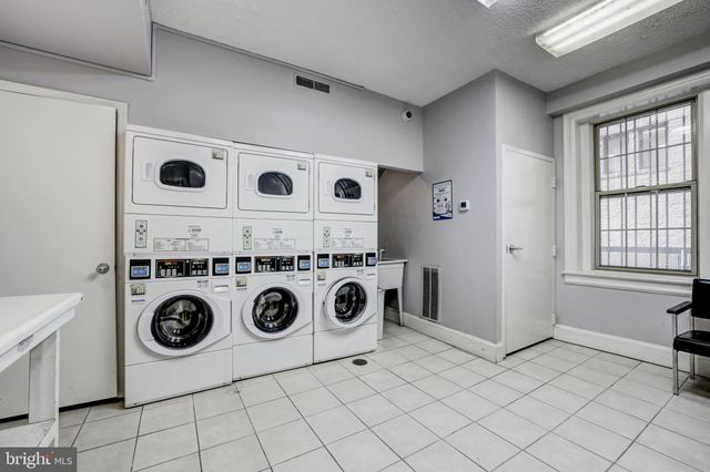 a view of a hallway with entryway and furniture