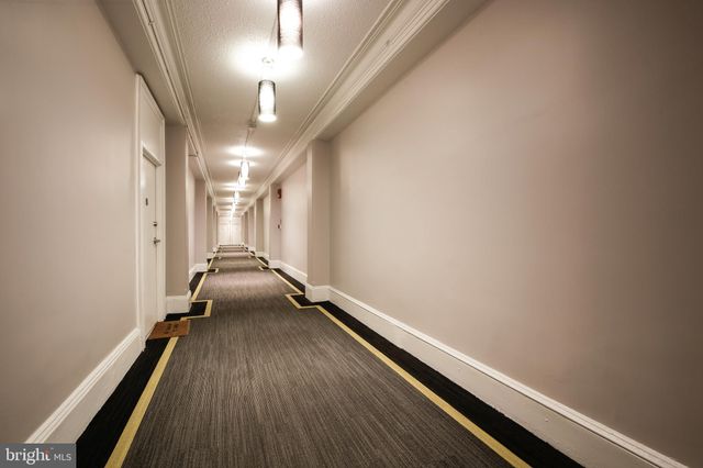 a kitchen with stainless steel appliances a stove a sink and white cabinets with wooden floor