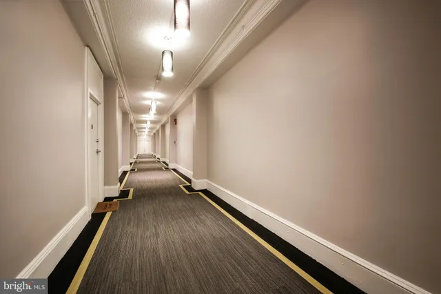 a kitchen with stainless steel appliances a stove a sink and white cabinets with wooden floor