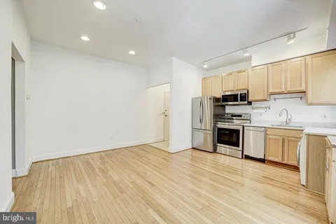 a view of kitchen with wooden floor electronic appliances and window