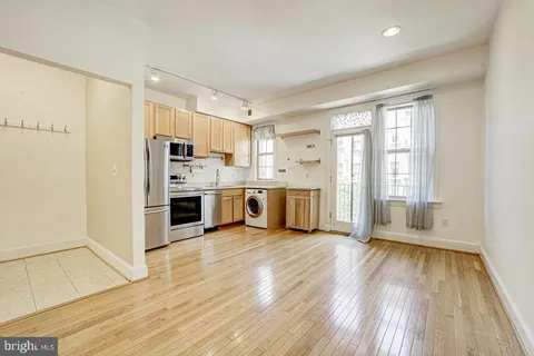 a kitchen with stainless steel appliances a refrigerator sink and microwave
