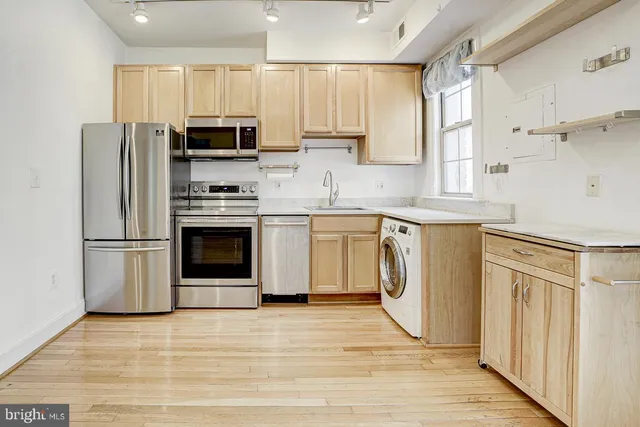 a kitchen with a stove a sink and a refrigerator