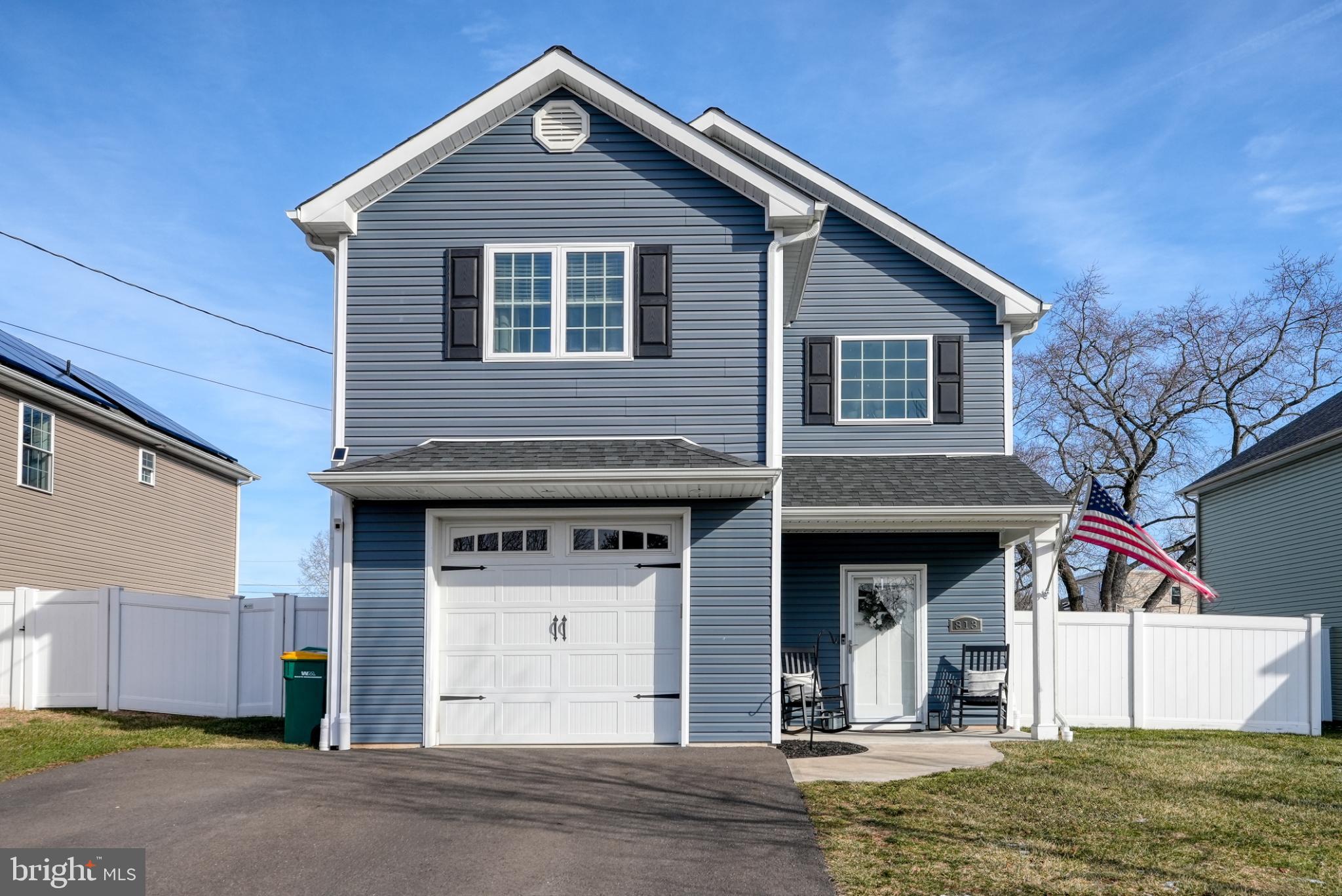 Charming blue home with inviting curb appeal.