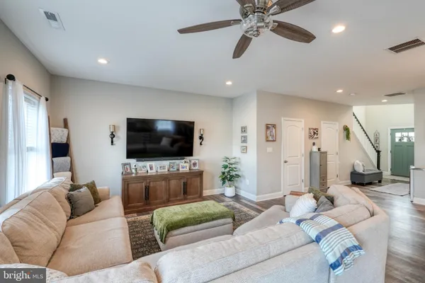 a living room with lots of furniture and kitchen view