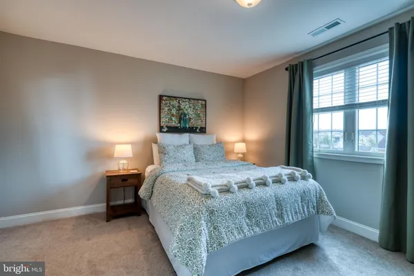 a bedroom with a bed and a lamp