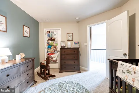 a bedroom with a bed a television and a large window