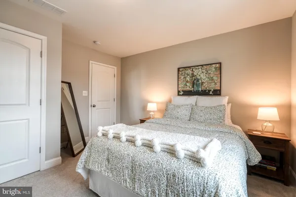a bedroom with a bed and a tv on table