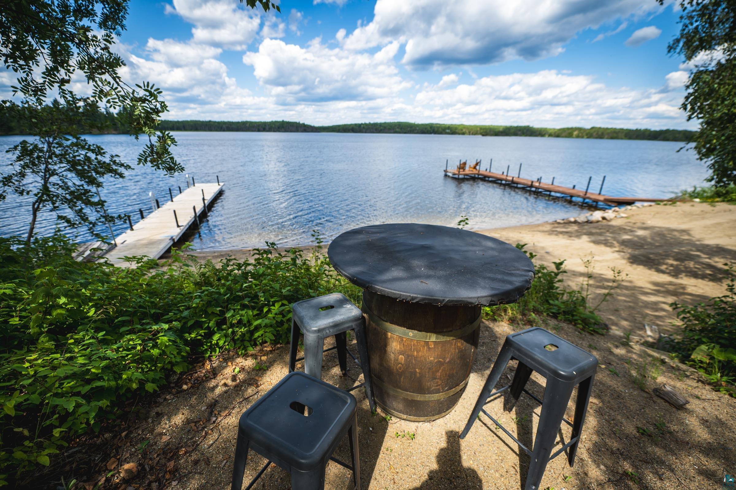 14635 Canadian Border Road Ely, MN 55731 - Photo 42 of 94 Waterfront property featuring a sandy shoreline, a long wooden dock, and a fixed pier