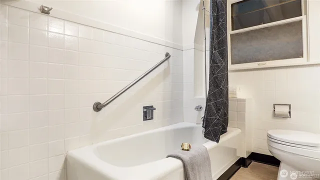a bathroom with a bathtub and shower
