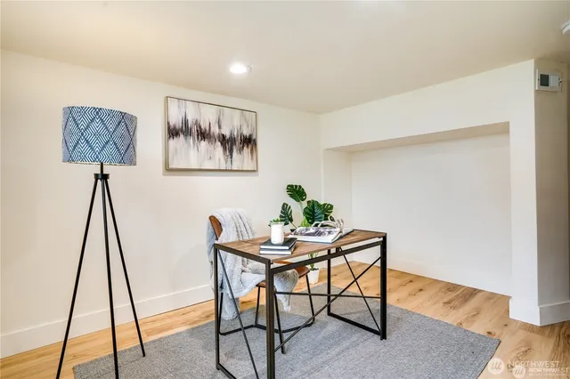 a view of a workspace with furniture and wooden floor