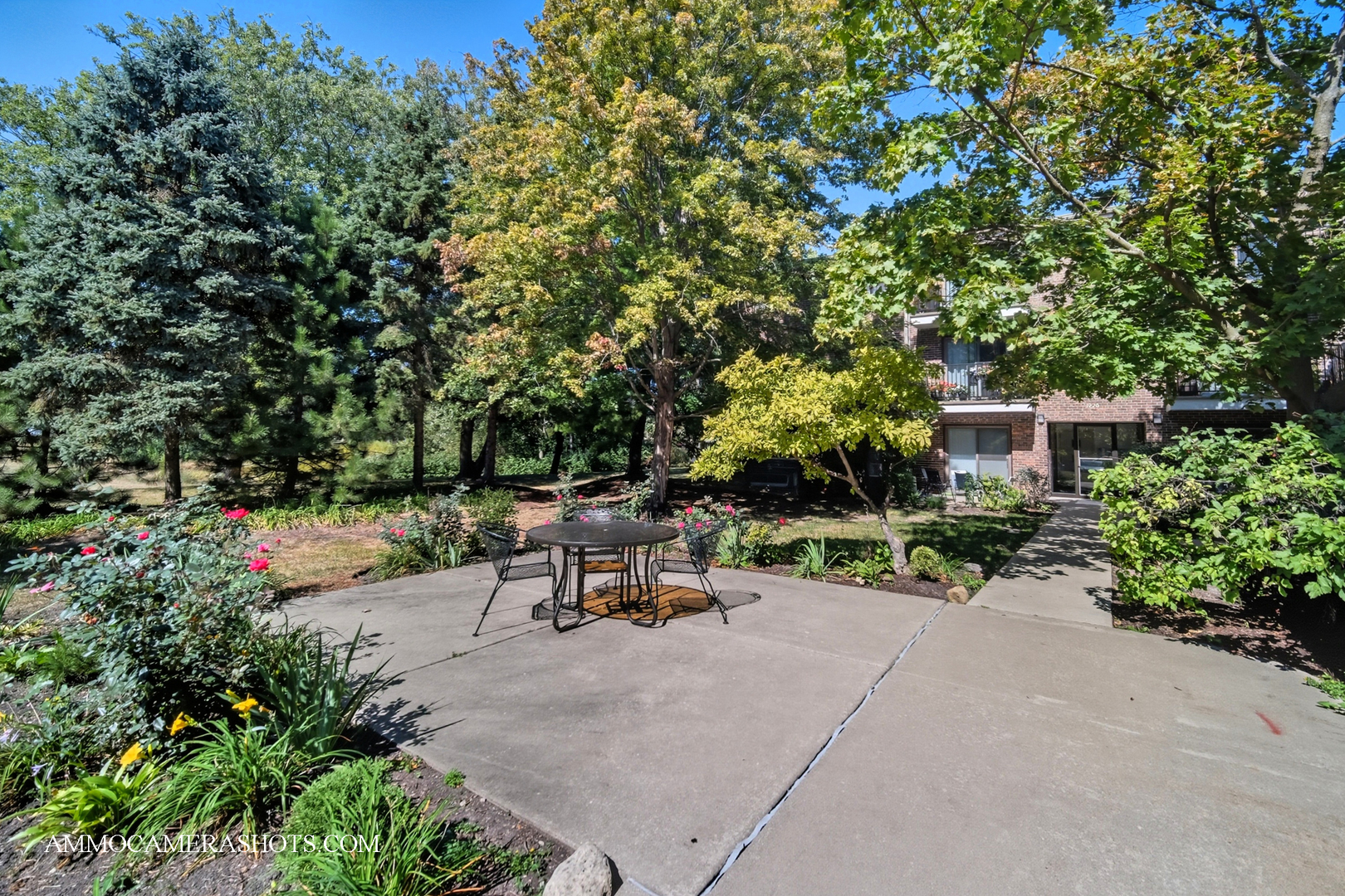 1240 South Lorraine Road, Unit 2D Wheaton, IL 60189 - Photo 18 of 19 a view of a bench sitting in a backyard