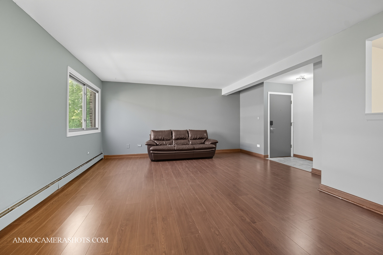 1240 South Lorraine Road, Unit 2D Wheaton, IL 60189 - Photo 6 of 19 a view of a livingroom with wooden floor and a window