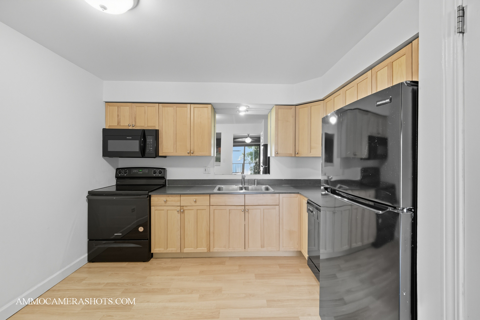 1240 South Lorraine Road, Unit 2D Wheaton, IL 60189 - Photo 8 of 19 a kitchen with stainless steel appliances granite countertop a stove a sink and a refrigerator