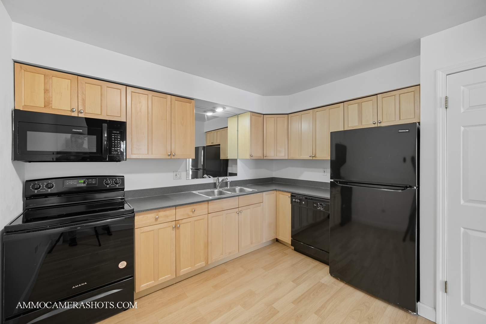 1240 South Lorraine Road, Unit 2D Wheaton, IL 60189 - Photo 9 of 19 a kitchen with a sink a microwave a refrigerator and cabinets