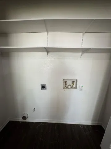 a view of a closet with wooden floor
