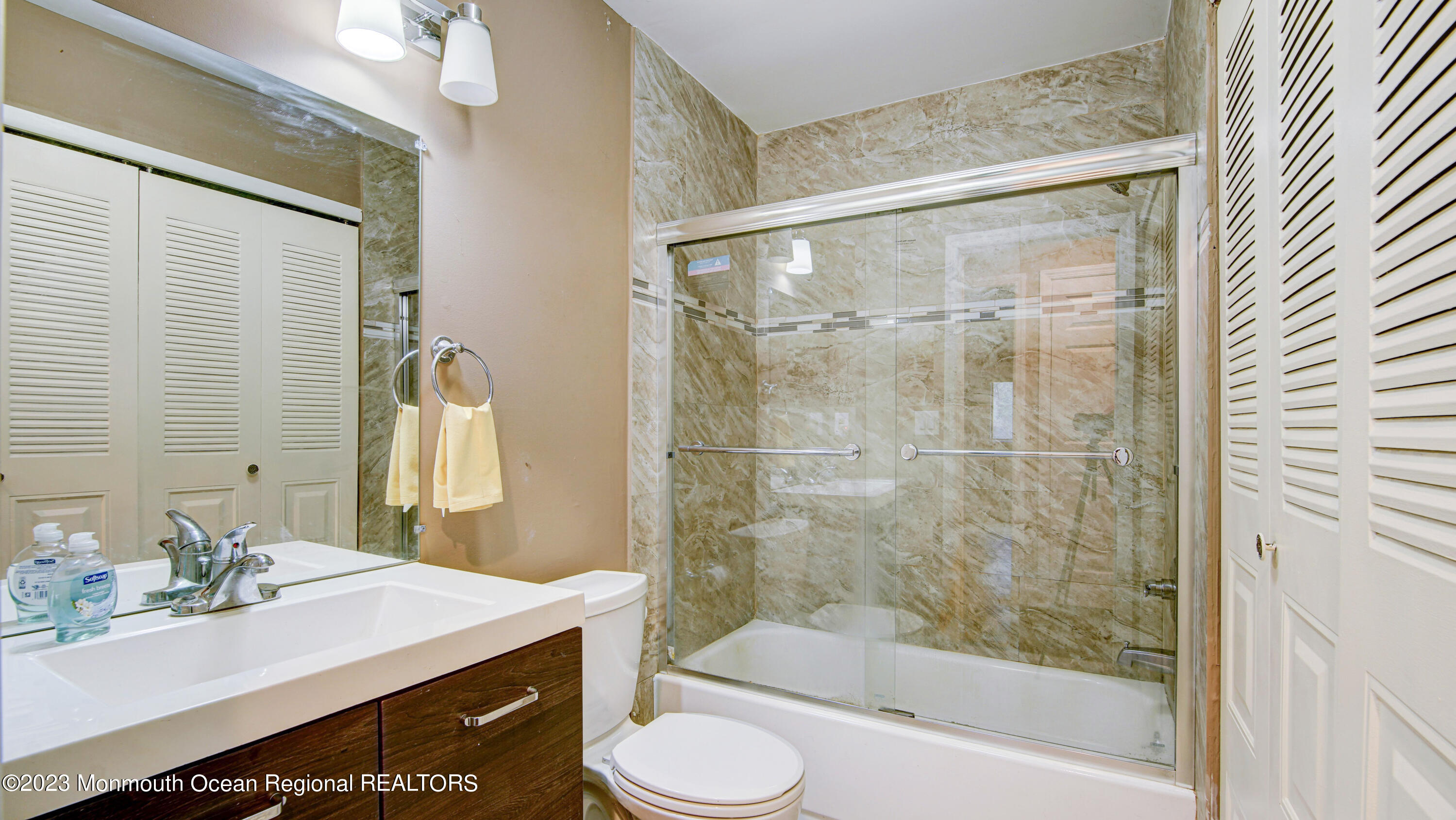 91 Arrowood Road, Unit B Manalapan, NJ 07726 - Photo 16 of 20 a bathroom with a sink toilet and shower