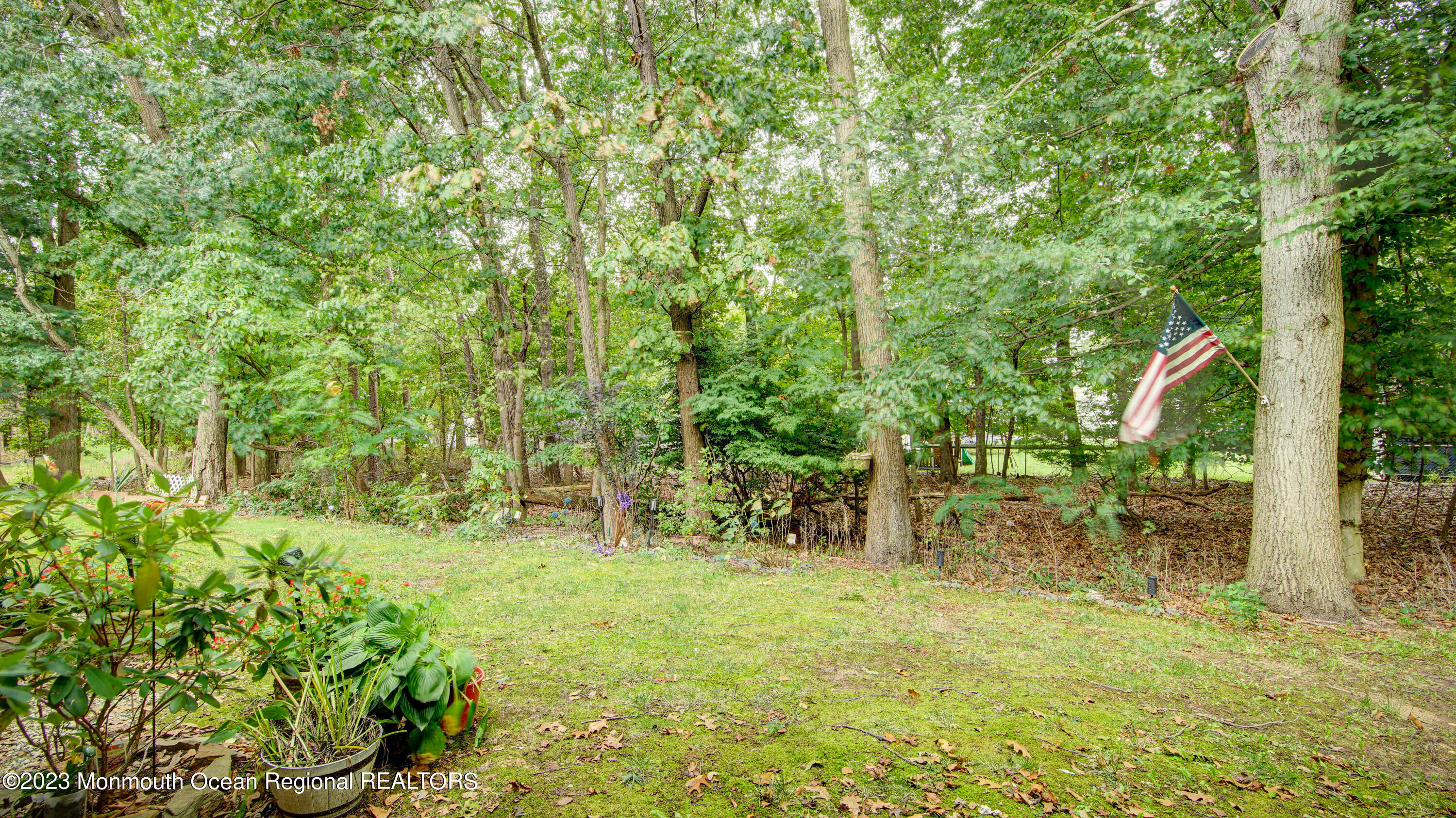91 Arrowood Road, Unit B Manalapan, NJ 07726 - Photo 18 of 20 a backyard of a house with lots of green space and garden