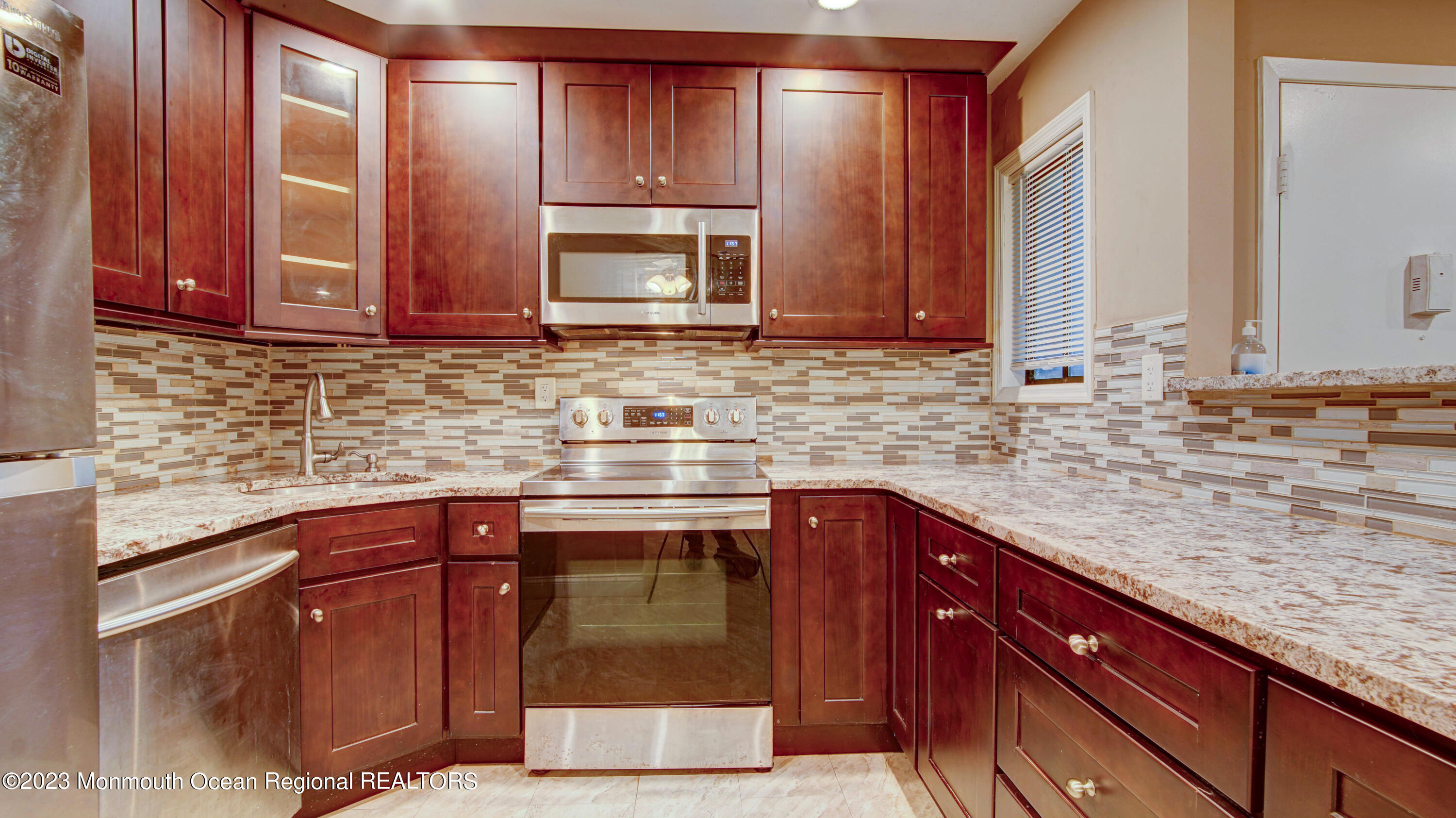 91 Arrowood Road, Unit B Manalapan, NJ 07726 - Photo 3 of 20 a kitchen with stainless steel appliances granite countertop a sink stove and cabinets
