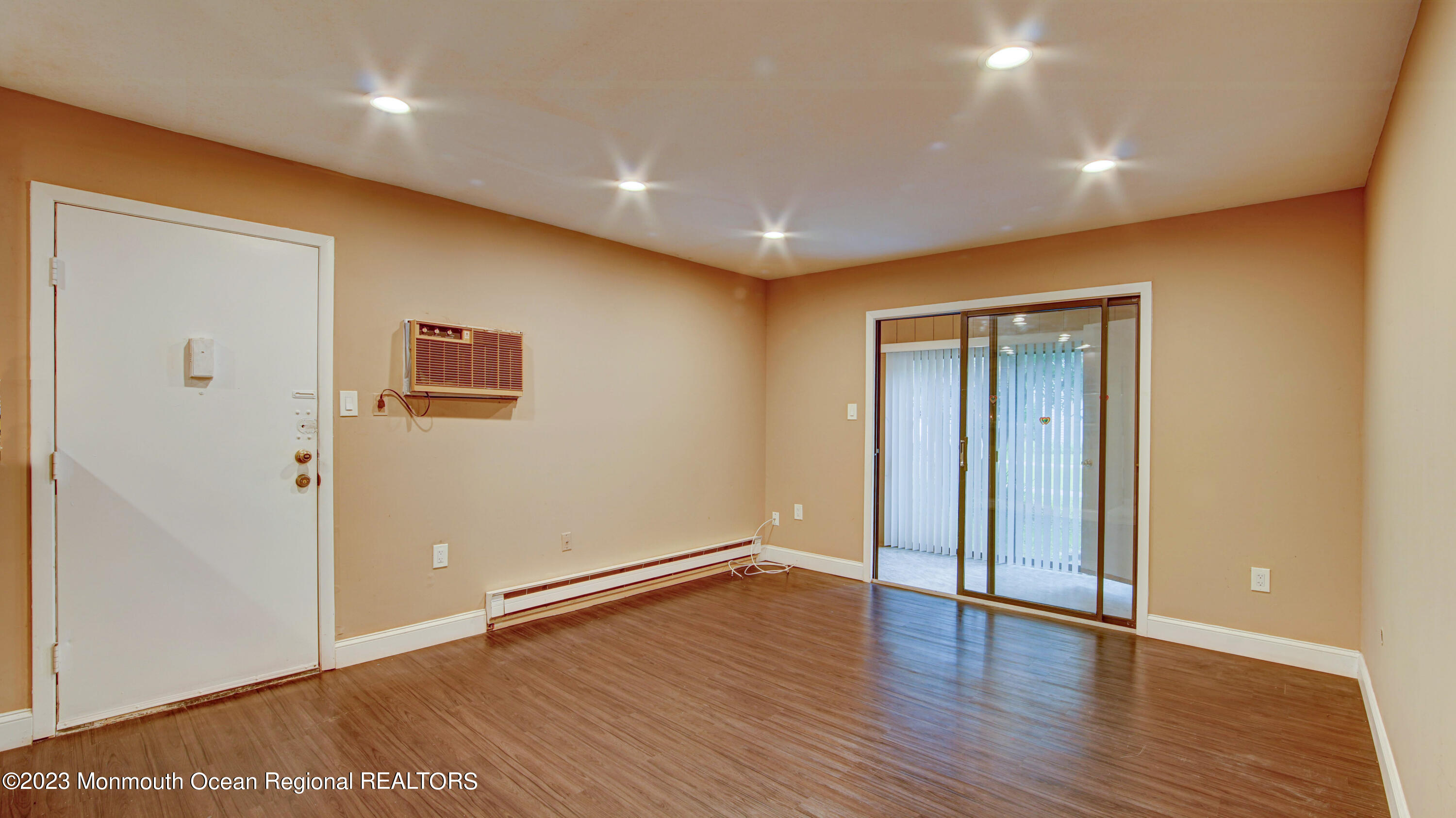 91 Arrowood Road, Unit B Manalapan, NJ 07726 - Photo 7 of 20 a view of an empty room with wooden floor