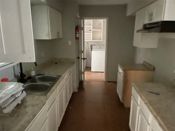 a kitchen with a sink and a refrigerator