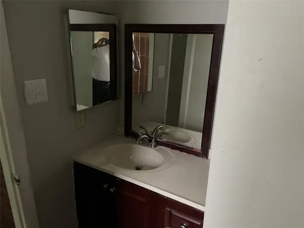 a bathroom with a sink and a mirror