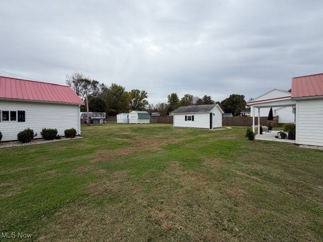 1097 Old River Road Boaz, WV 26187 - Photo 19 of 21 View of yard featuring a storage shed and a patio