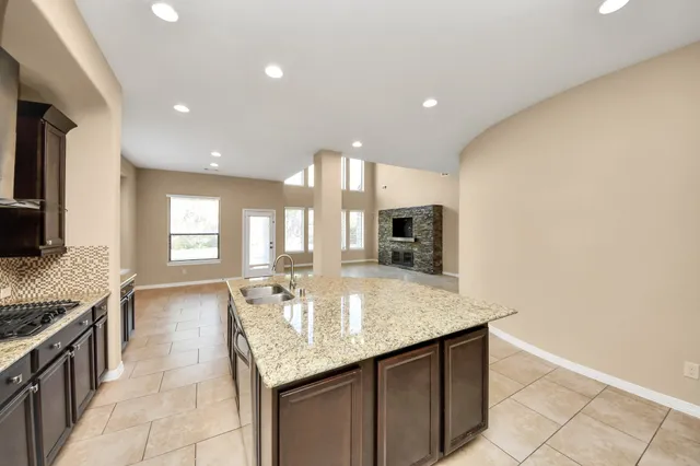 a kitchen with stainless steel appliances granite countertop a stove and a sink