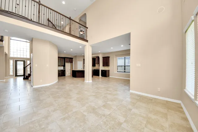 a view of an empty room with a fireplace and a window
