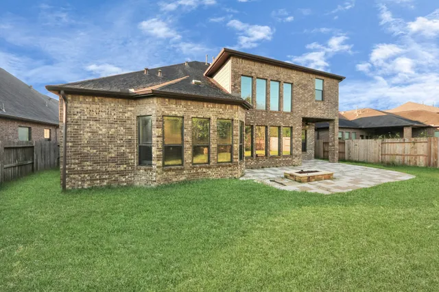 a view of a house with a yard and sitting area