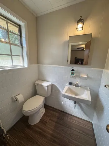 a bathroom with a toilet sink and mirror