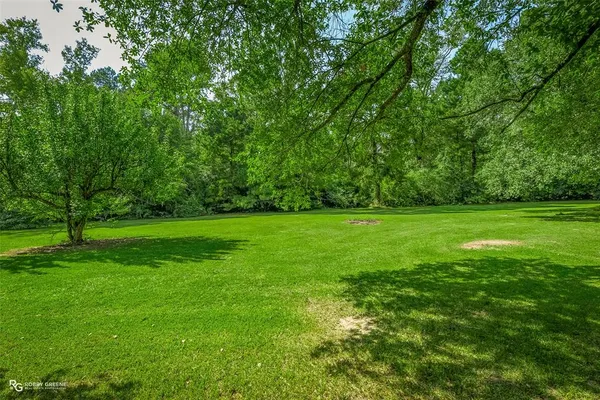 a view of a house with backyard and porch