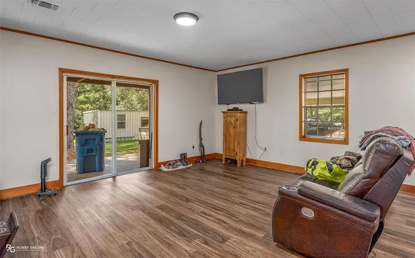 a living room with furniture and a floor to ceiling window