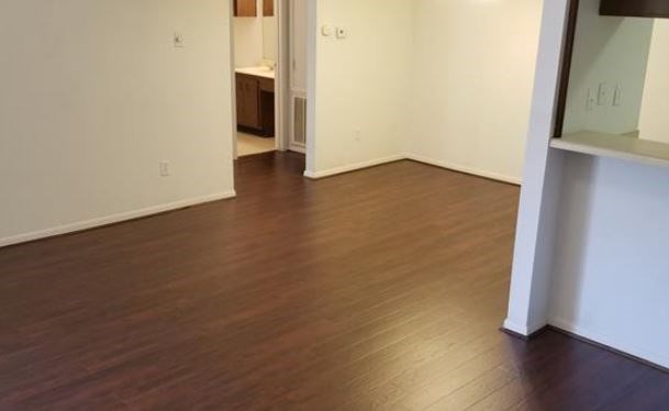 8100 Cambridge Street, Unit 89 Houston, TX 77054 - Photo 3 of 15 a view of an empty room with wooden floor and a window