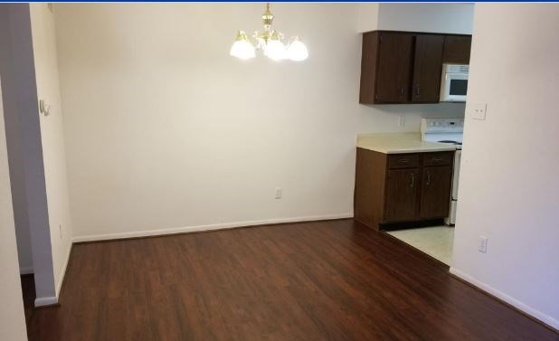 8100 Cambridge Street, Unit 89 Houston, TX 77054 - Photo 4 of 15 a view of an empty room with wooden floor and a window