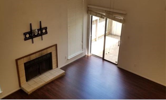 8100 Cambridge Street, Unit 89 Houston, TX 77054 - Photo 5 of 15 a view of a livingroom with wooden floor and a fireplace