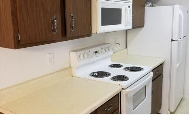 8100 Cambridge Street, Unit 89 Houston, TX 77054 - Photo 10 of 15 a kitchen with a microwave and a stove